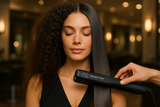 beautiful model with long thick hair using this AG care midnight heat tourmaline ionic professional flat iron to smooth out curly frizzy hair into straight glassy shiny healthy hair